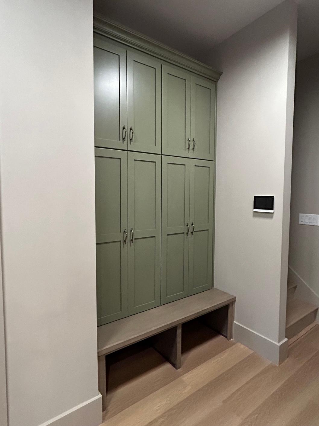 Built-in cabinetry with a bench seating area and open cubbies below.