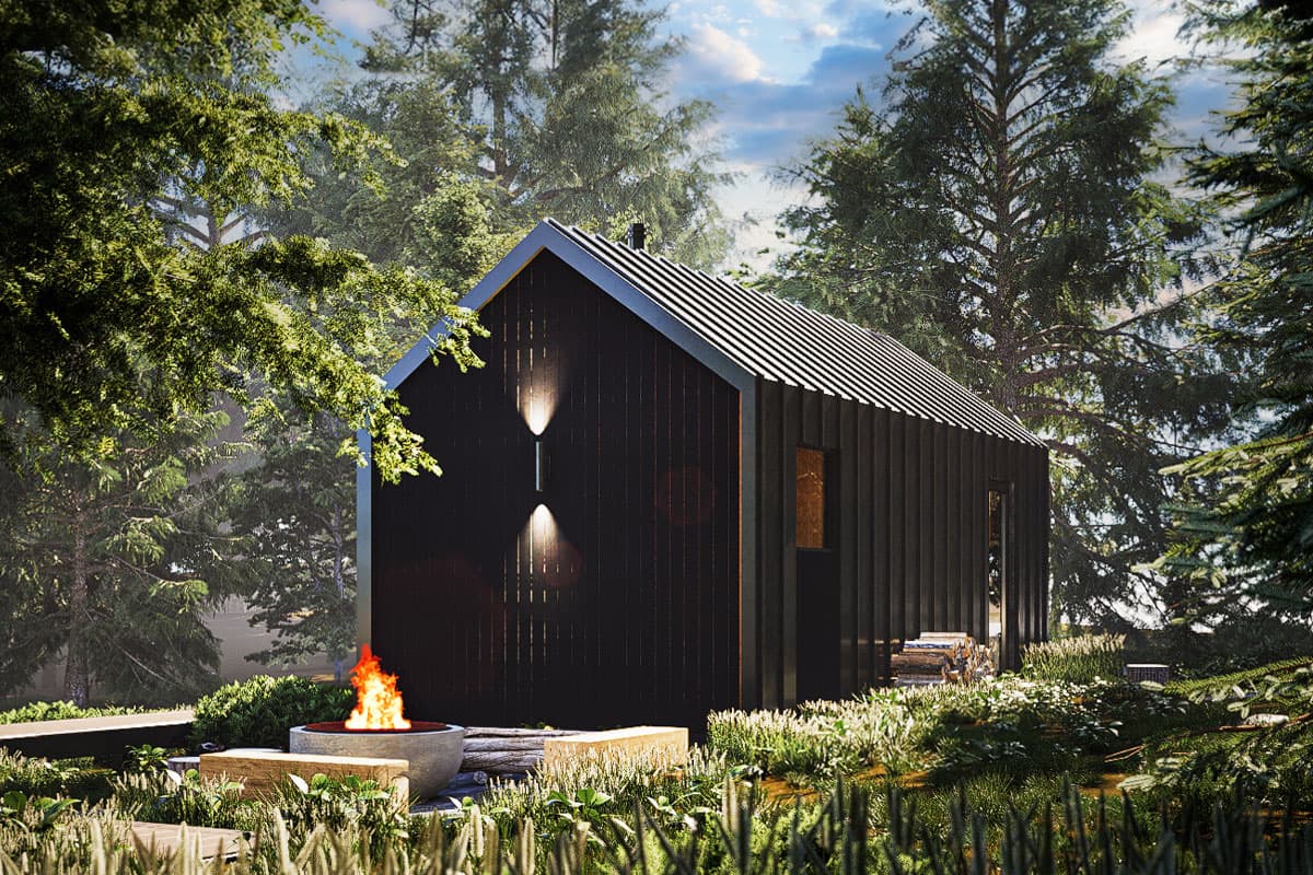 Modern cabin exterior with dark vertical siding, gabled roof, and exterior sconces. Fire pit in foreground.