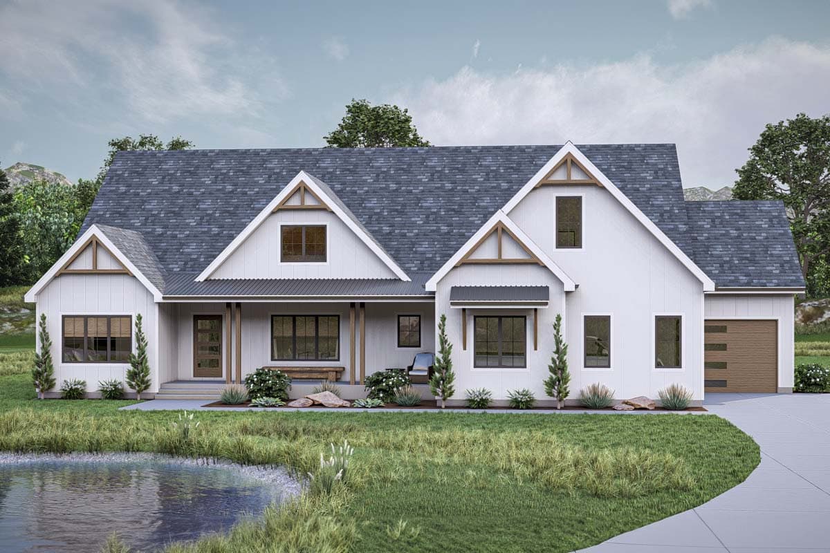 House plan exterior. Modern Farmhouse style with two stories, gabled rooflines, a covered porch, and a detached garage.