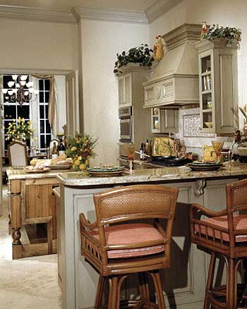 Kitchen island with granite countertop, bar seating, ornate range hood, and built-in ovens.