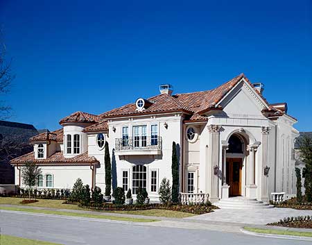 House plan exterior: Mediterranean style, two stories, arched entry, wrought iron balcony, and red tile roof.