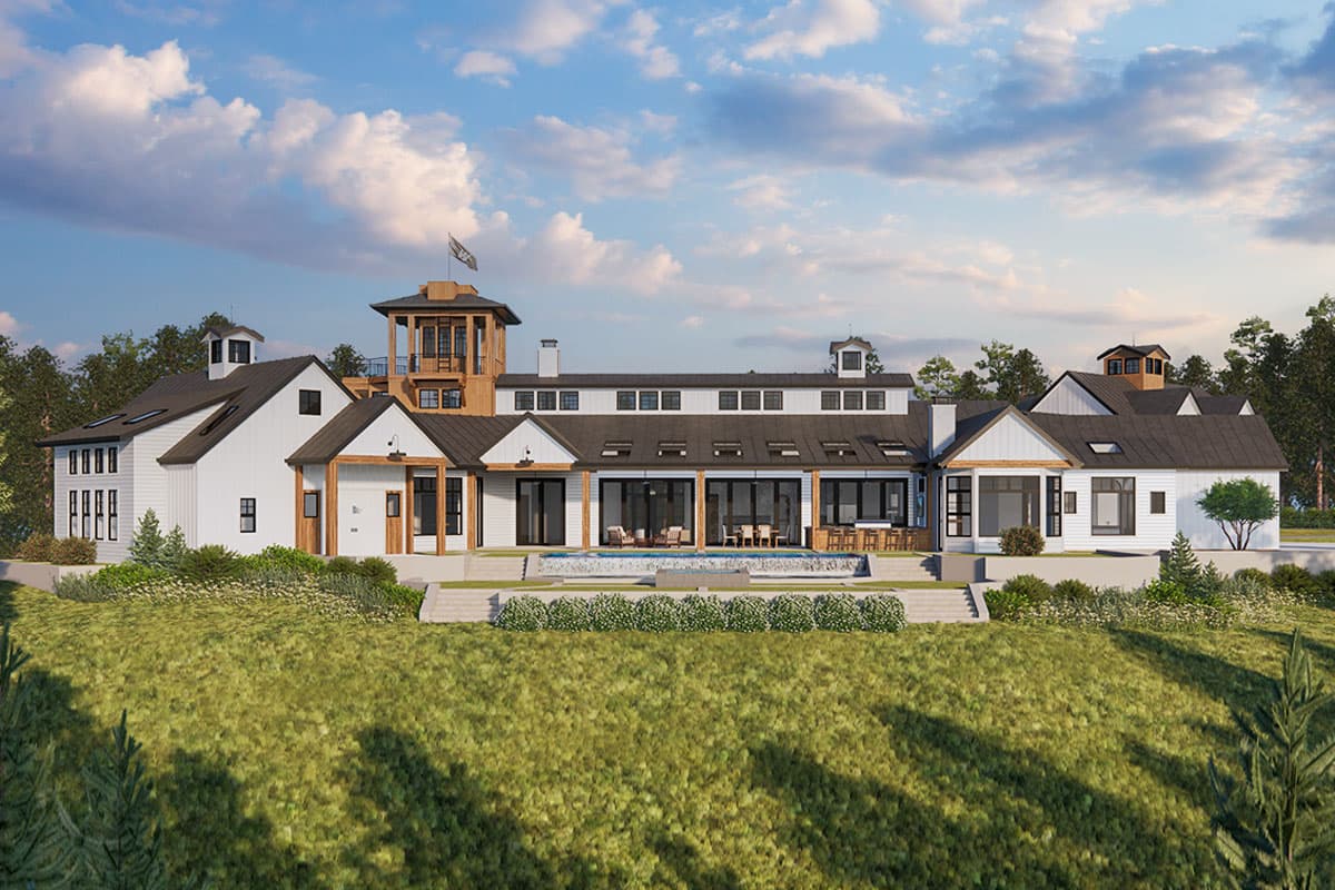 Modern farmhouse house plan exterior with gabled rooflines, multiple dormers, a central tower, and a covered rear patio with pool.