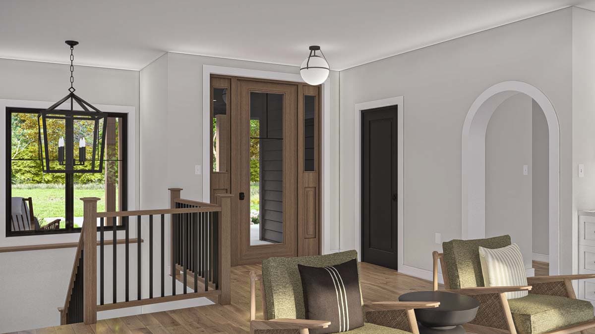 Interior view of house plan: entry with wood double doors, staircase with black railing, and arched doorway.