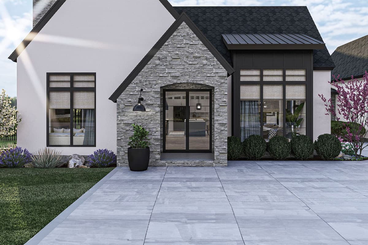 House plan exterior with stone-clad entry, gabled roofline, and large grid windows.