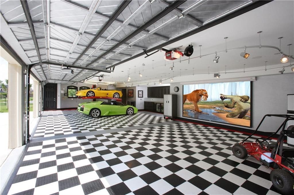 Garage with checkered floor, car lift holding two sports cars, projection screen, and a go-kart.