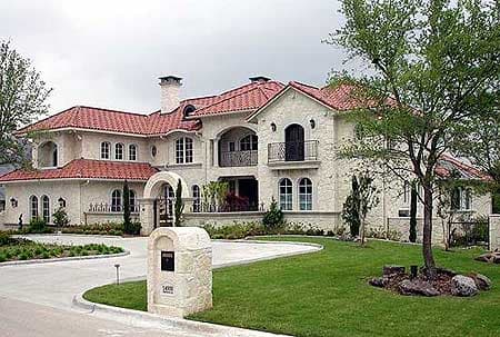 House plan exterior of a two-story Mediterranean-style home with a red tile roof, arched windows, and balconies.