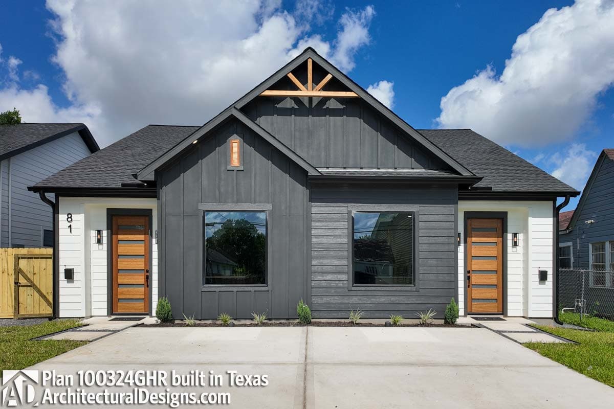Modern house plan exterior with vertical and horizontal siding, gabled roof, exposed rafter tails, and wood-paneled doors.