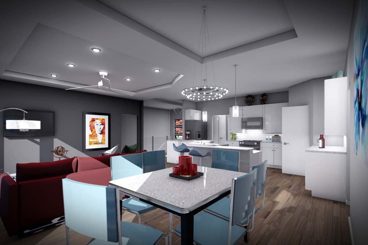 Open concept living area and kitchen with dining table, bar stools, stainless steel appliances, and sectional sofa.