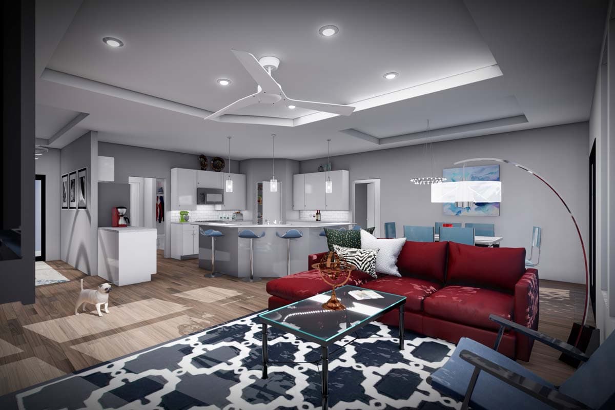 Open concept living area with modern kitchen island, red sectional sofa, dining area, and recessed ceiling.