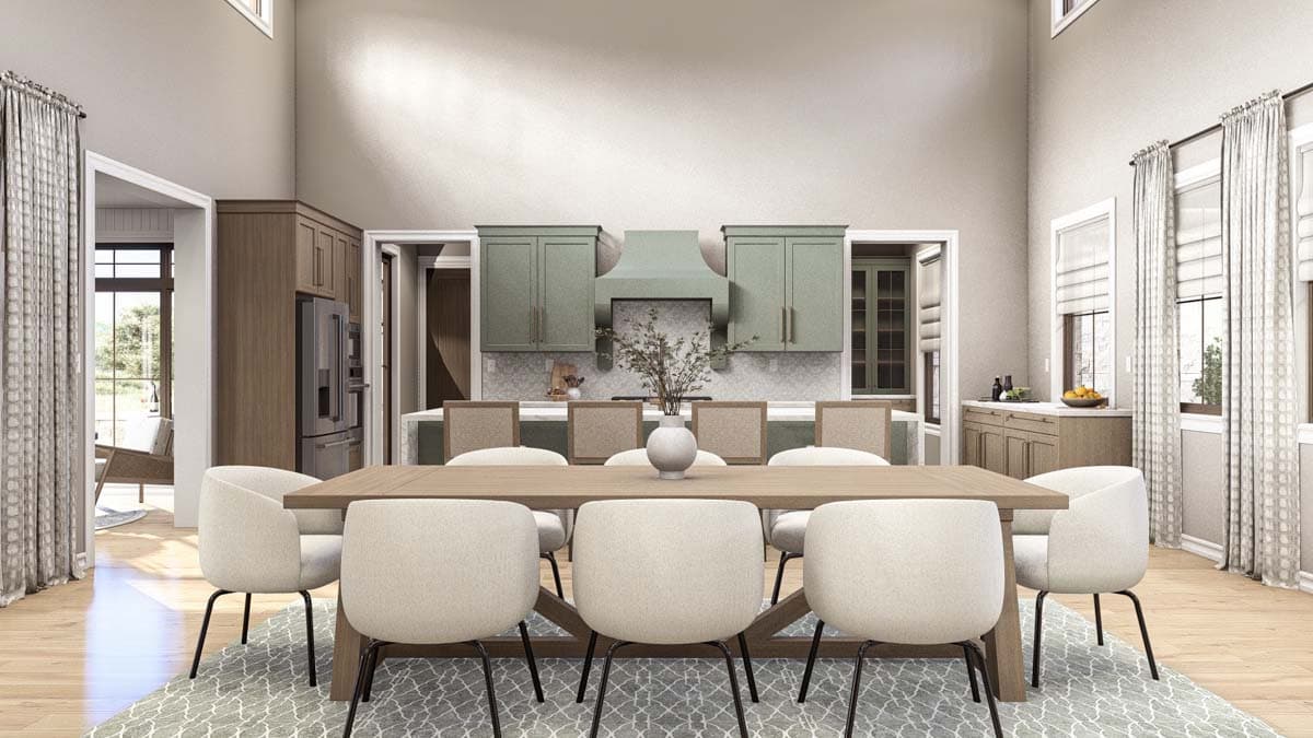 Render of a dining area with a large table, chairs, and kitchen with sage green cabinets and stainless steel refrigerator.