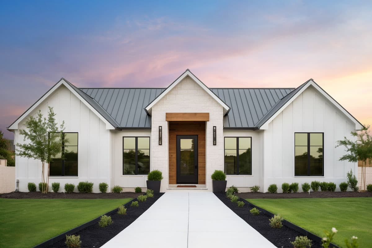 House plan exterior. Modern Farmhouse style with a single story, board and batten siding, metal roof, and gabled entry.