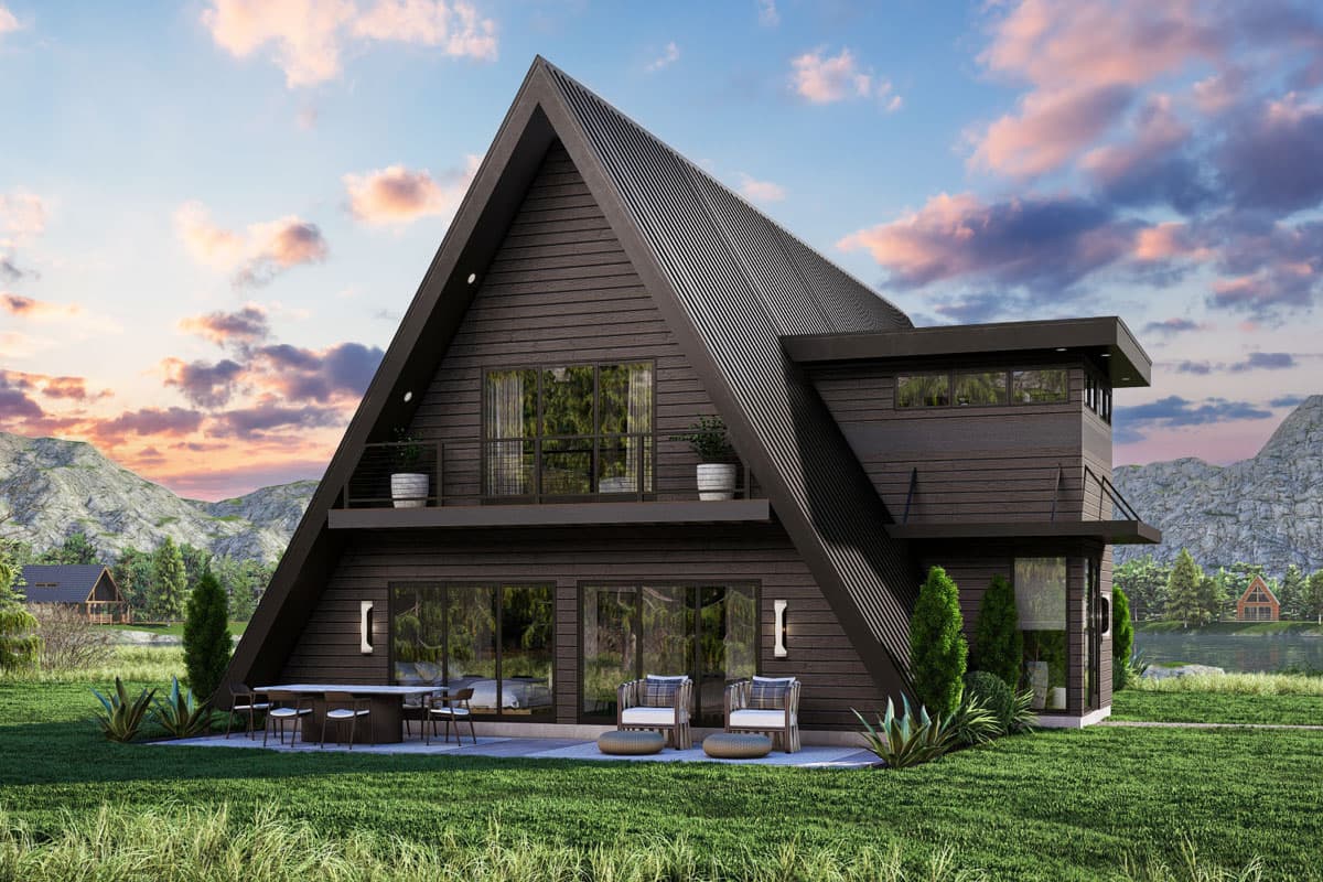 House plan exterior. A-frame style home with a high-pitched roof, balcony, and shed roof over a side addition. Two stories with large windows.