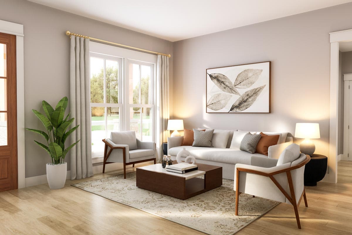 Interior view of a living room with a sofa, two chairs, coffee table, large windows, and artwork.