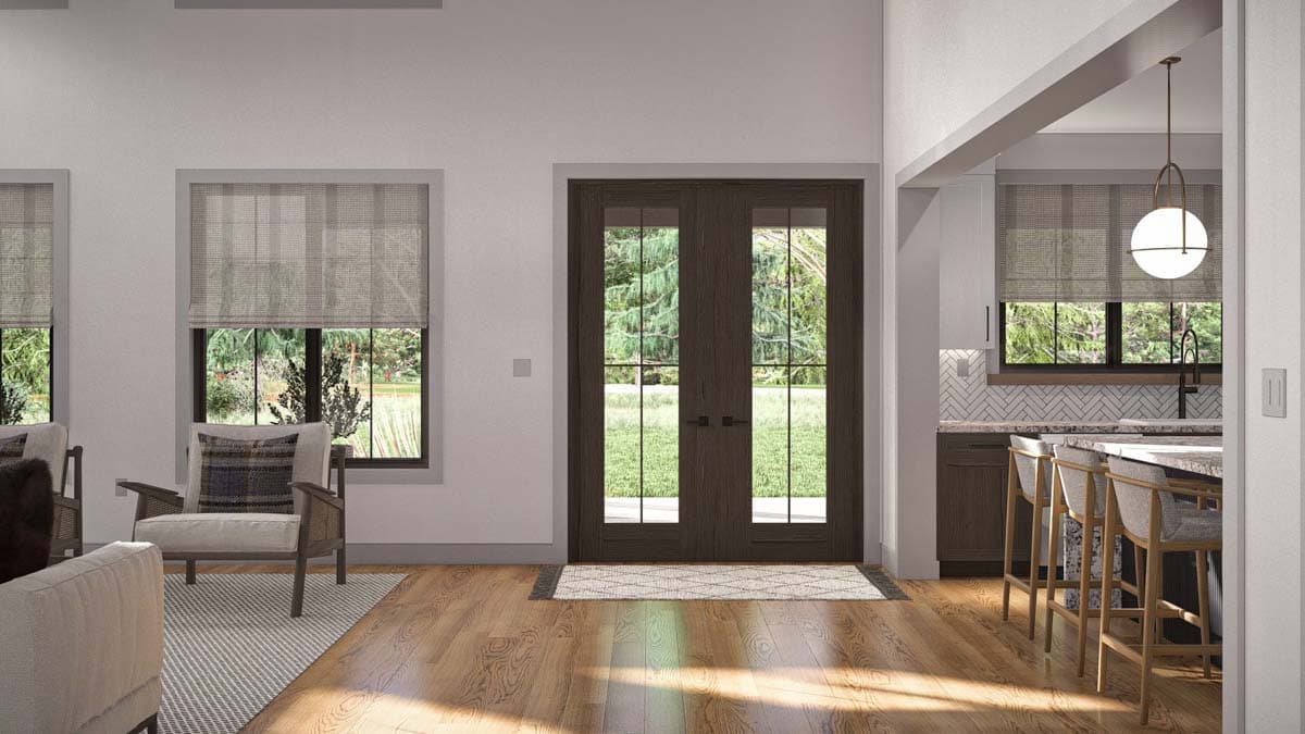 Interior view of a living space with double doors, island seating, and herringbone tile backsplash.