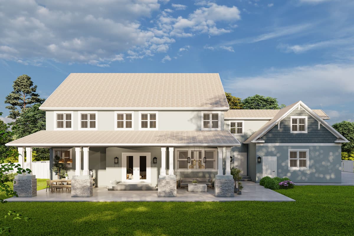 Two-story house plan exterior with wrap-around porch, stone columns, multiple gables, and shingle siding.