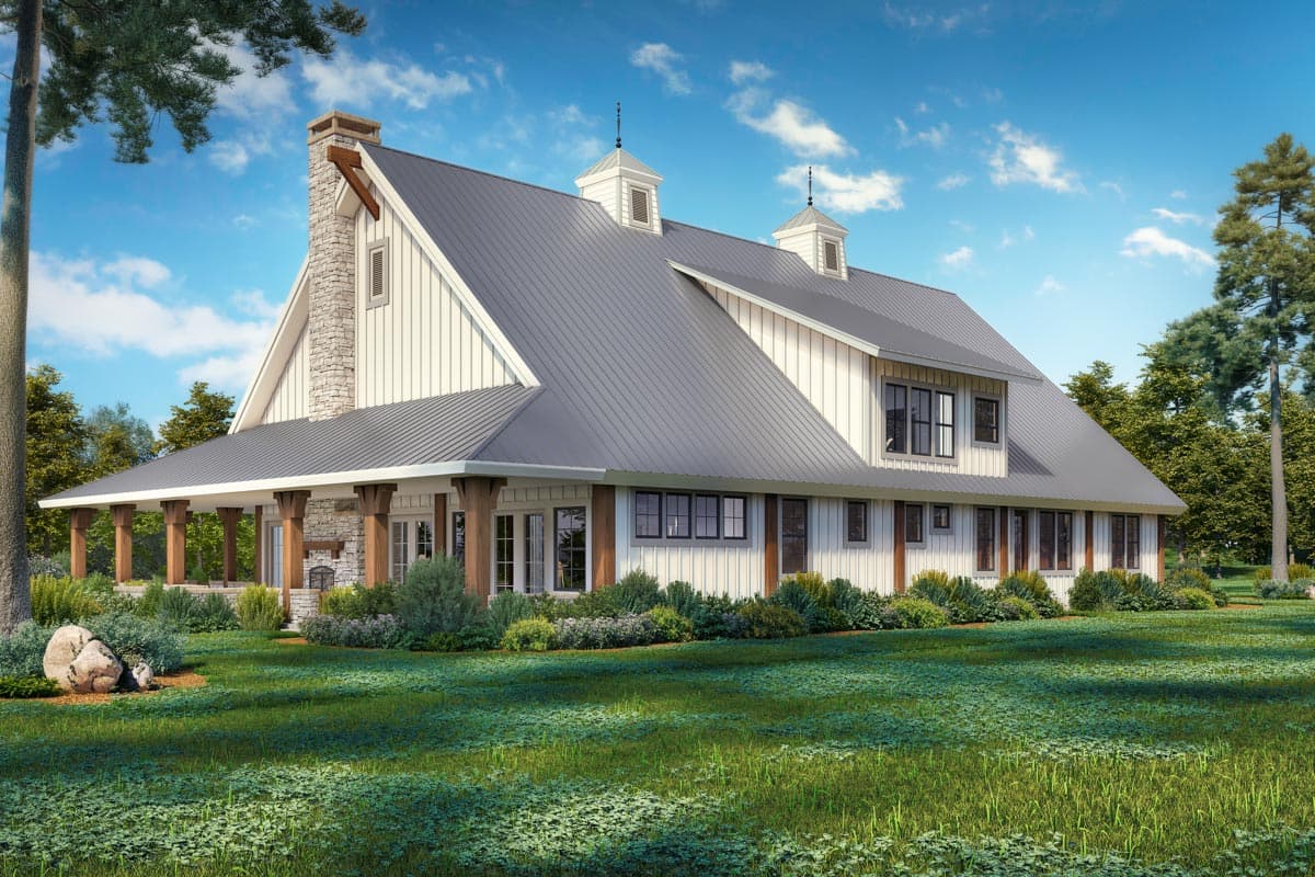 Modern Farmhouse house plan exterior with wrap-around porch, metal roof, stone chimney, and cupolas.