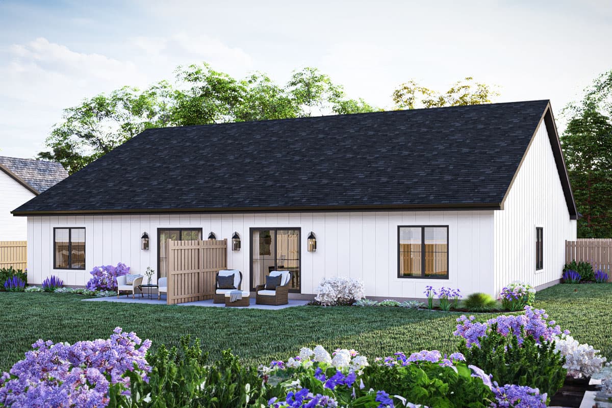 Modern Farmhouse house plan exterior, one story, white board and batten siding, dark roof, patio with seating, and large windows.