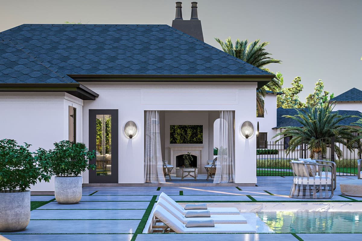 Modern house exterior with dark pitched roof, white stucco walls, glass door, outdoor seating, and pool.