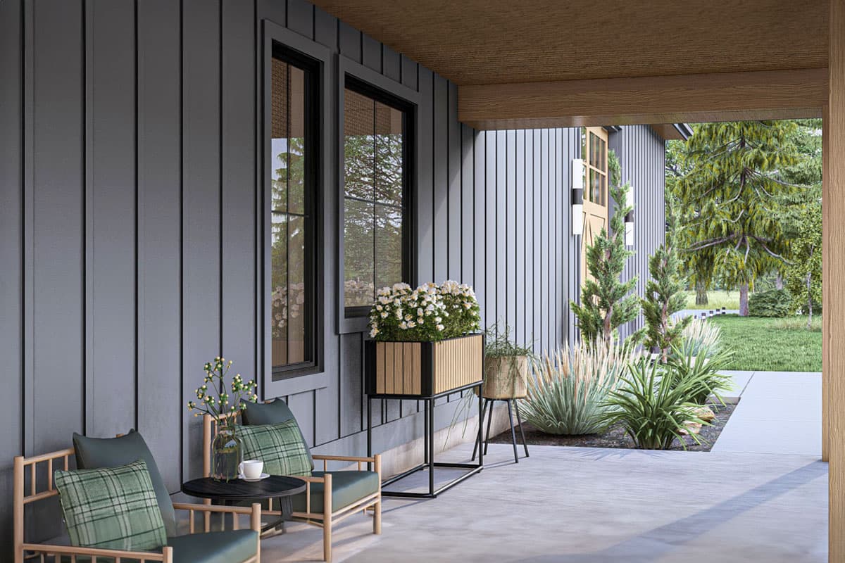 Modern house plan exterior with vertical siding, dark framed windows, covered porch, and outdoor seating.