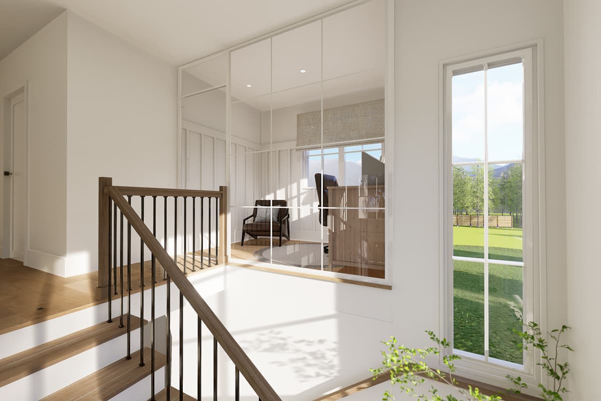 A modern interior with a staircase and a study seen through a large window. A view of a green field is visible outside the window.