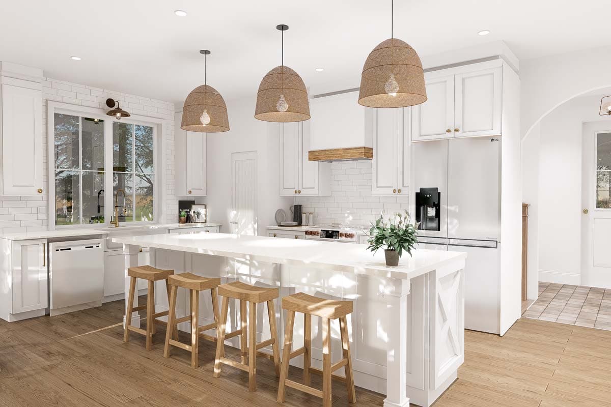Modern farmhouse kitchen with large island, white cabinetry, subway tile backsplash, farmhouse sink, and pendant lighting.