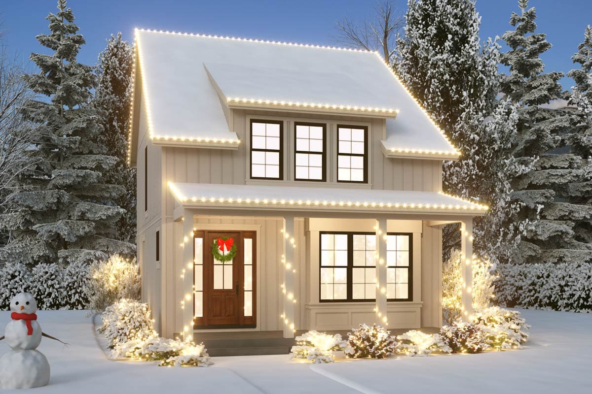 Two-story house plan exterior with a covered front porch, dormer, and board and batten siding, decorated with holiday lights and snow.