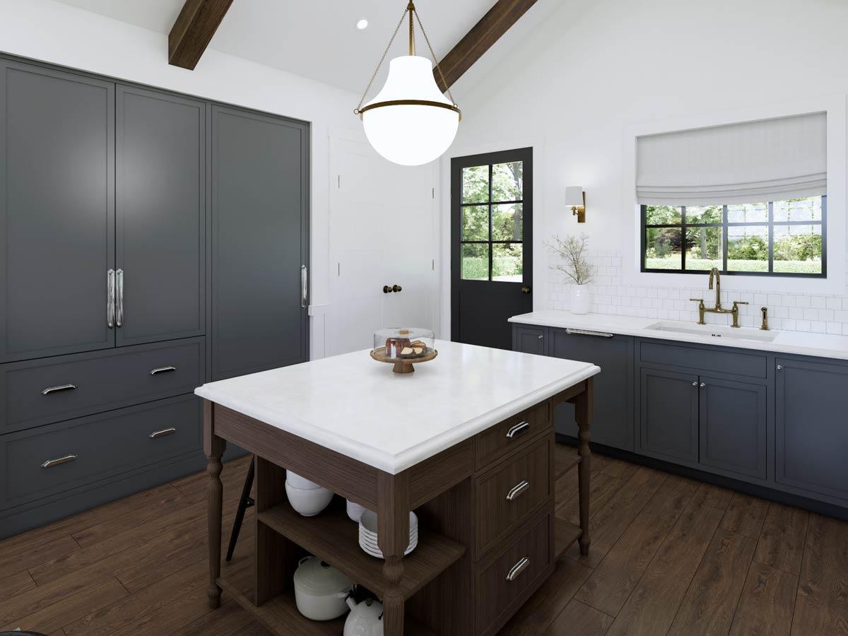 A modern kitchen with dark blue cabinetry, a white marble island, and a decorative pendant light. A door and window allow natural light to enter.