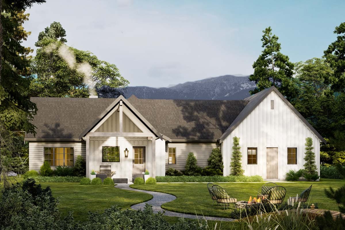 A white farmhouse with a stone path leading to the front porch. Smoke rises from a chimney. Chairs sit around a fire pit in the yard.