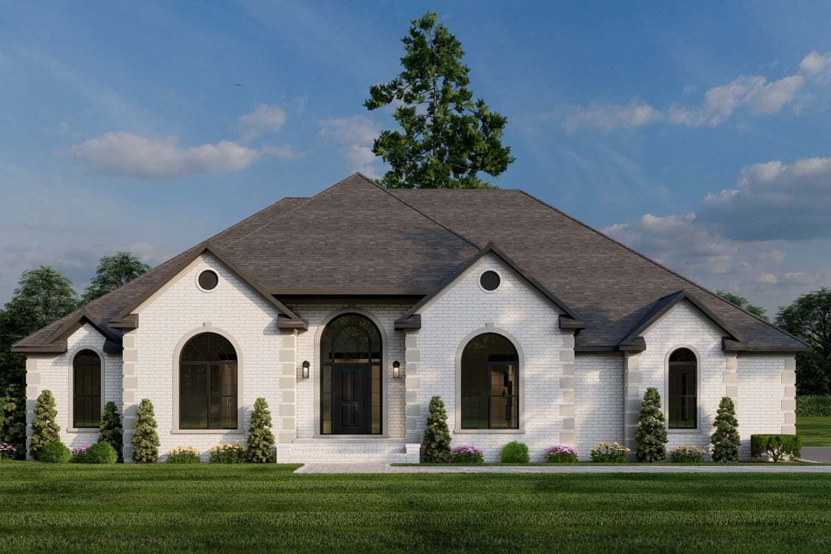 House plan exterior with brick facade, arched windows, and gabled roof. Features include a front entry with sidelights and dormers.