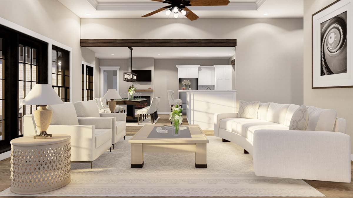Open-concept living area with white sofas, a dining table, kitchen island, fireplace, and exposed wood beam.