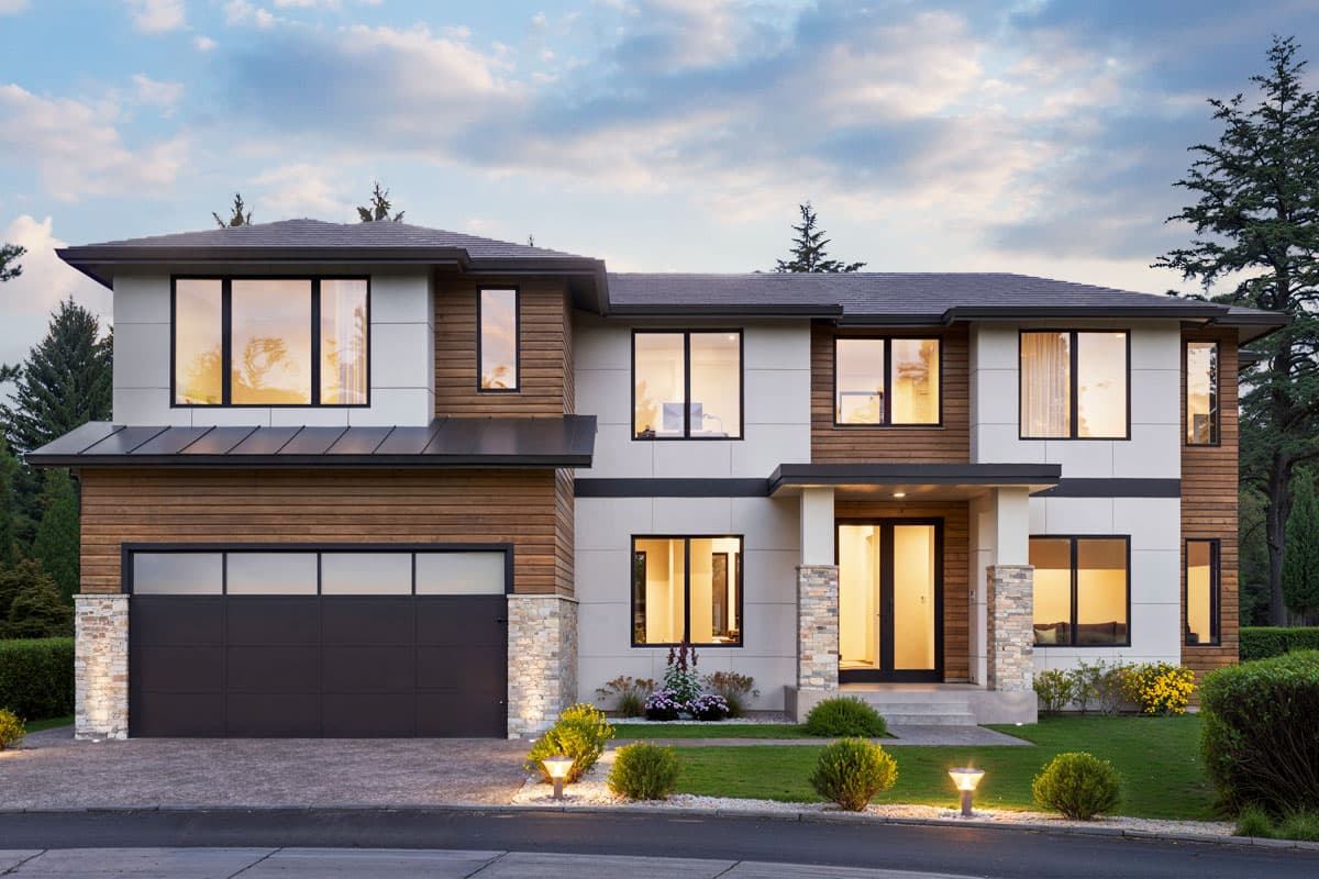 House plan exterior. Two-story modern house with a flat roof, wood siding accents, large windows, and an attached garage.
