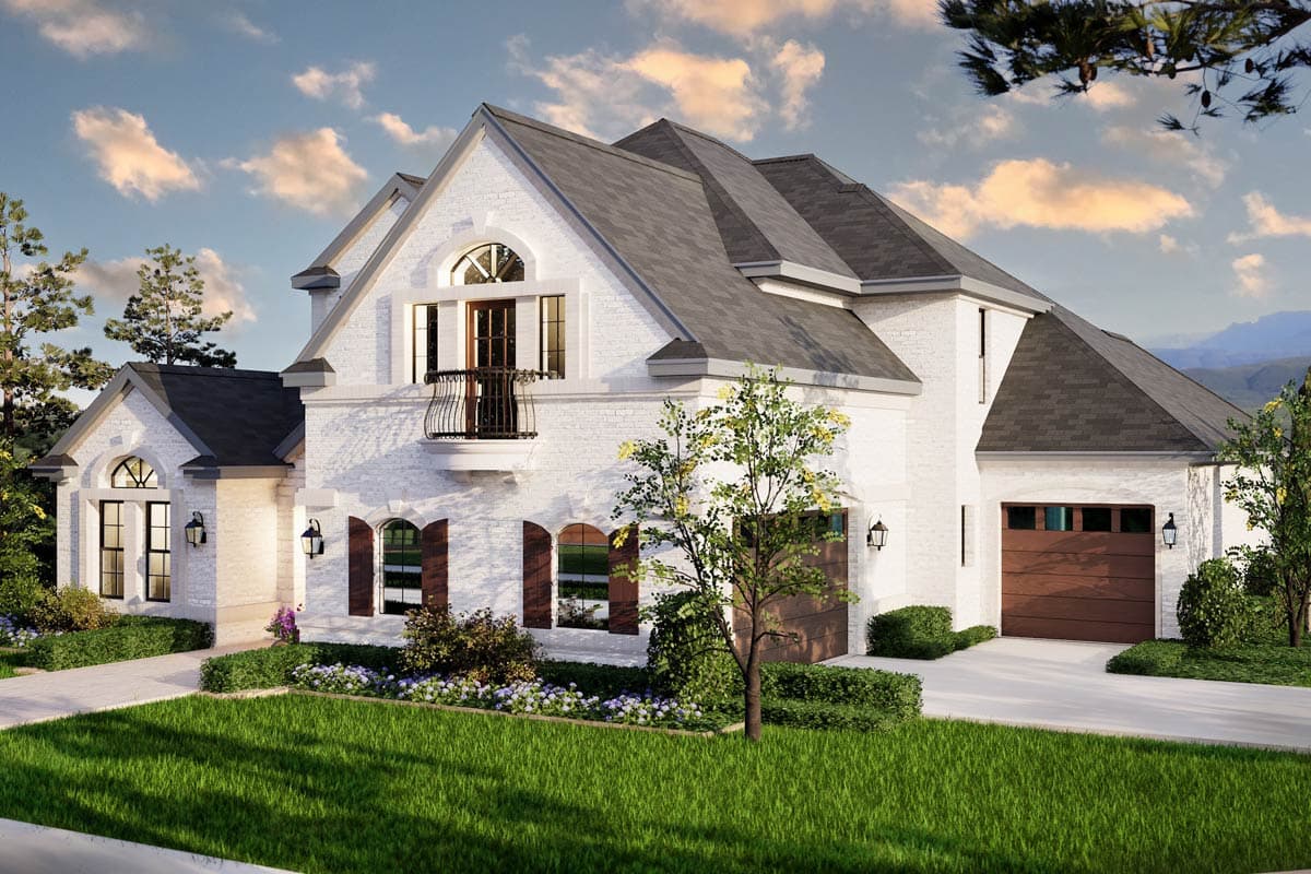 House plan exterior: two-story white brick home with gabled roof, arched windows, balcony, and two-car garage.