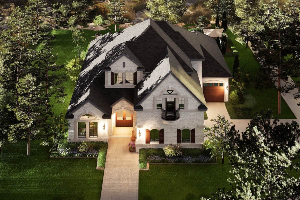 House plan exterior: Two-story stone home with hipped roof, dormers, arched entryway, balcony, and attached garage.