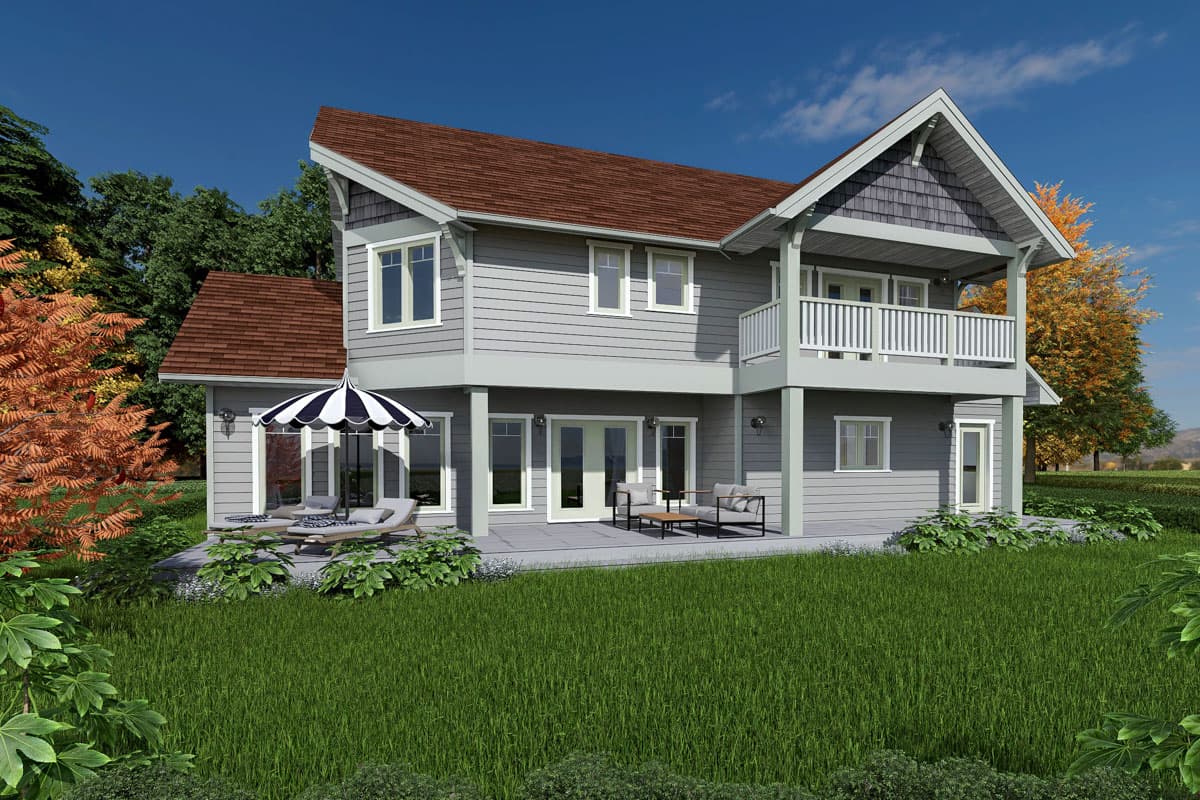 House plan exterior, two stories, grey siding, gabled dormer, upper balcony with white railing, lower patio with seating.