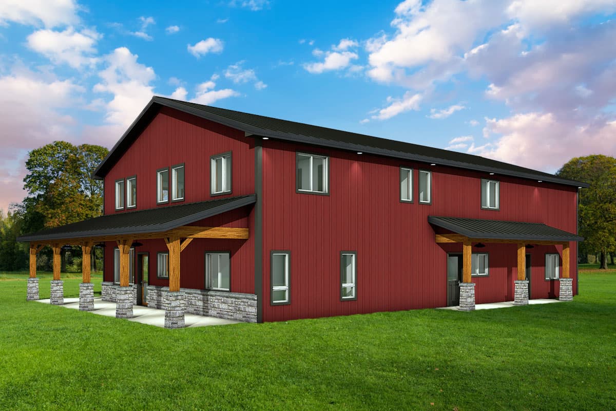A two-story red barn-style house with black roofing and porches supported by stone and wooden pillars, set against a blue sky.