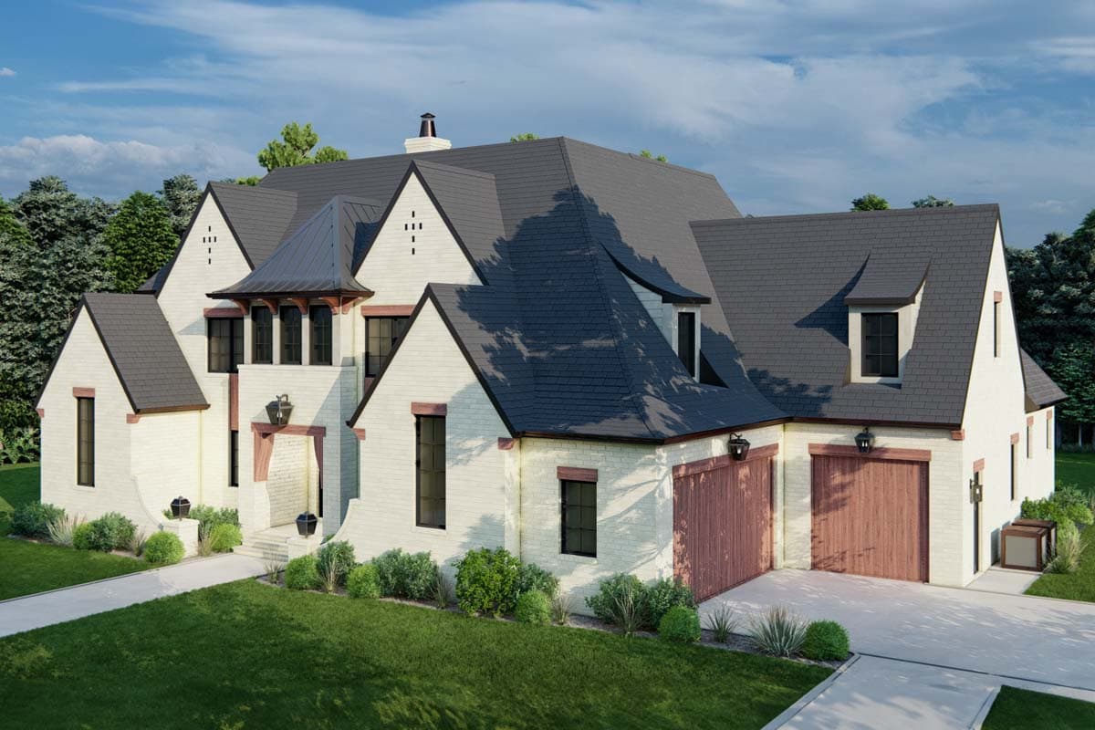 House plan exterior: White brick home with multiple gables, dormers, dark roof, and two wooden garage doors.