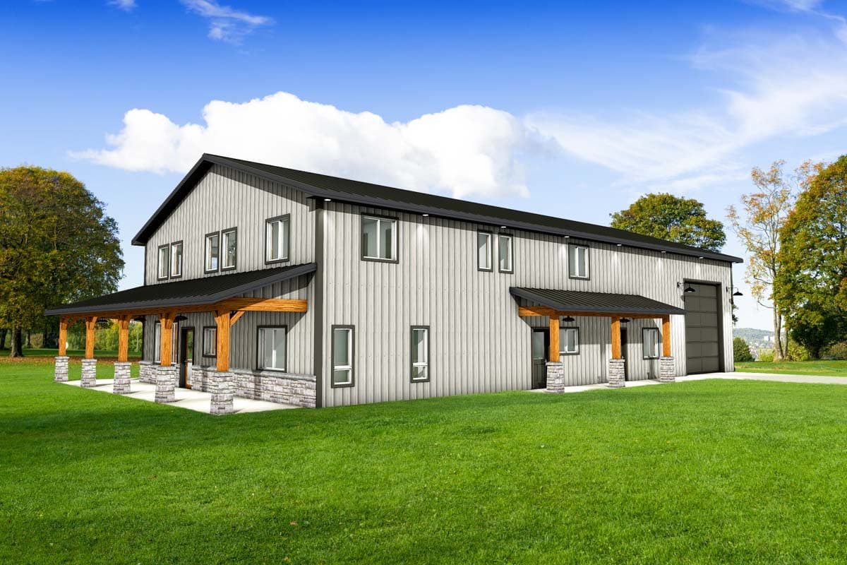 A two-story building with a light-gray corrugated metal facade, black roof, and wooden porch with stone columns stands on a grassy lawn.