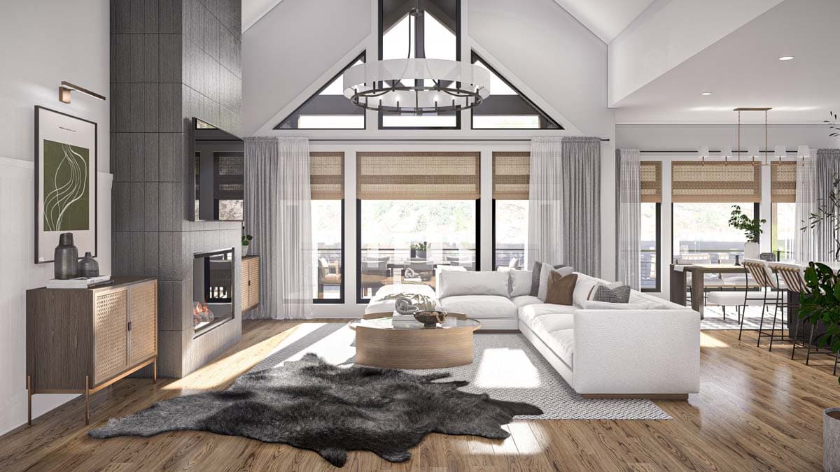 Modern great room with vaulted ceiling, stone fireplace, large windows, and open dining area.