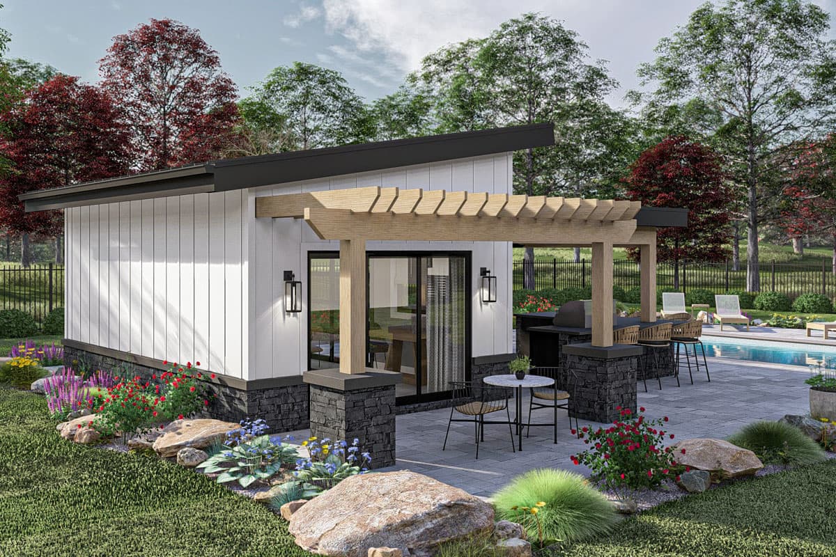 Modern house plan exterior with white vertical siding, flat roof, wood pergola, and stone base. Features outdoor kitchen and seating area.