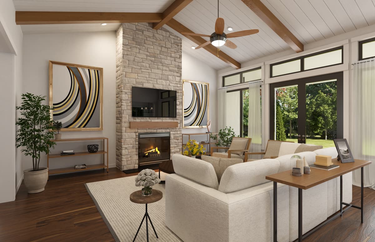 Open concept living area with vaulted beamed ceiling, stone fireplace, and large glass doors.