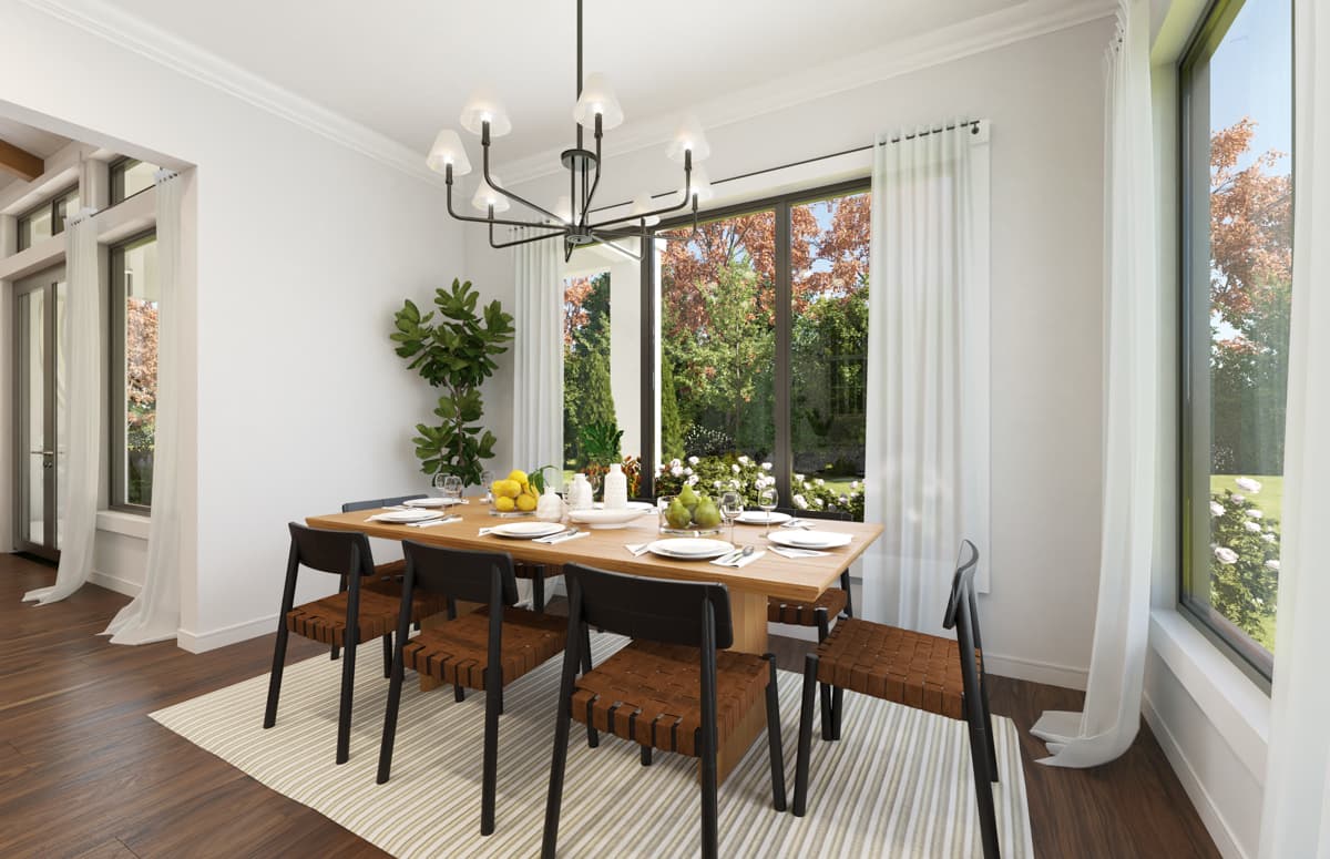 Dining room with a large wooden table set for a meal, minimalist chairs, a modern chandelier, and expansive windows overlooking a garden.