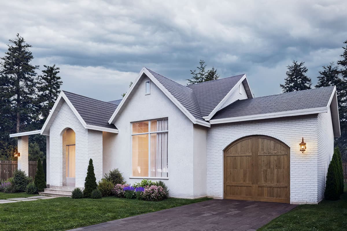 House plan exterior of a one-story home with arched entryway, gabled dormer, white brick accents, and wood garage door.