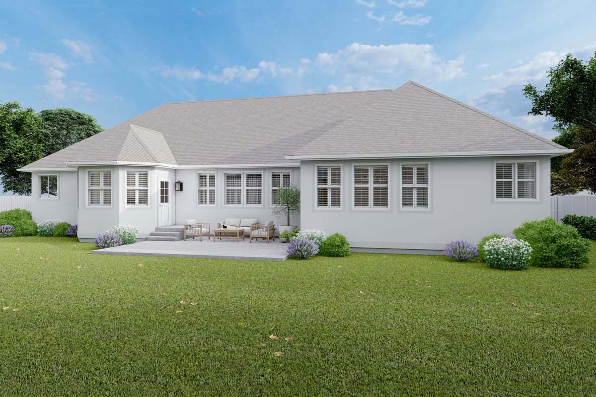 House plan exterior: Single-story home with a hip roof, multiple windows, and a rear patio with outdoor seating.