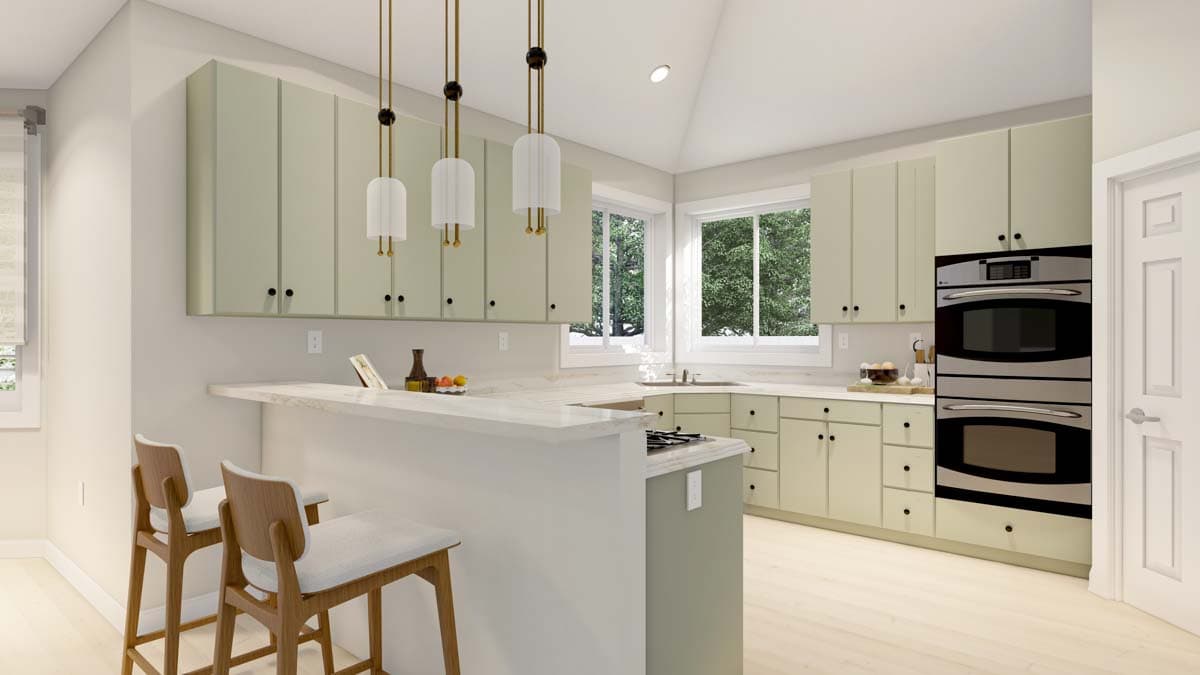 Modern kitchen with vaulted ceiling, light green cabinetry, island with counter seating, and stainless steel double ovens.