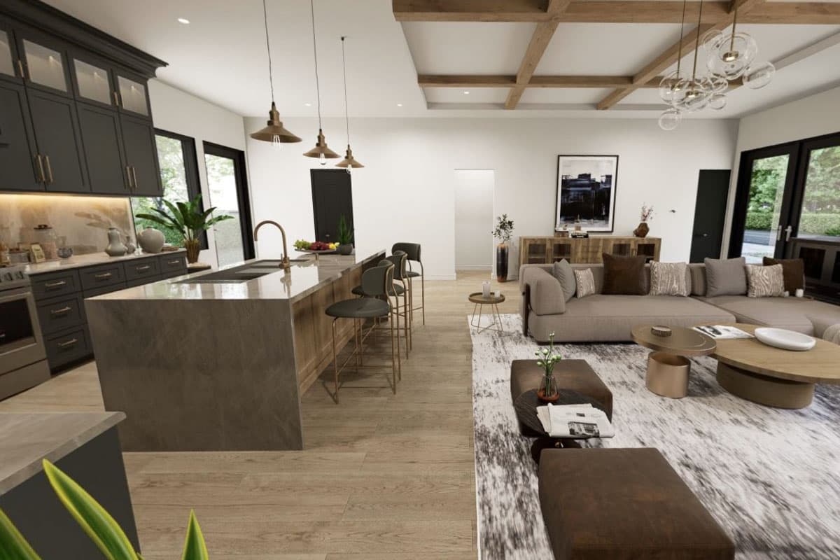 Modern open-concept living area with a dark gray kitchen island, island seating, and a sectional sofa.