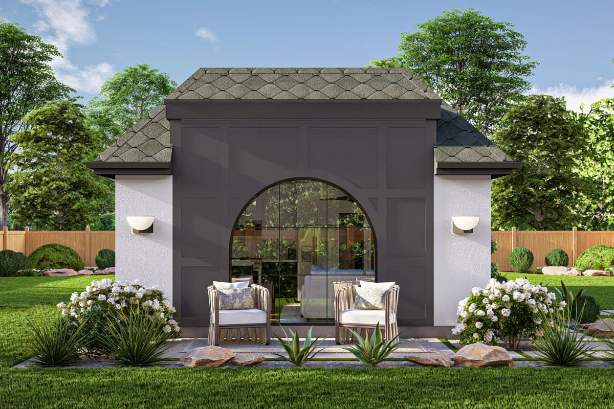 House plan exterior with gambrel roof, stucco walls, arched window, and decorative facade.