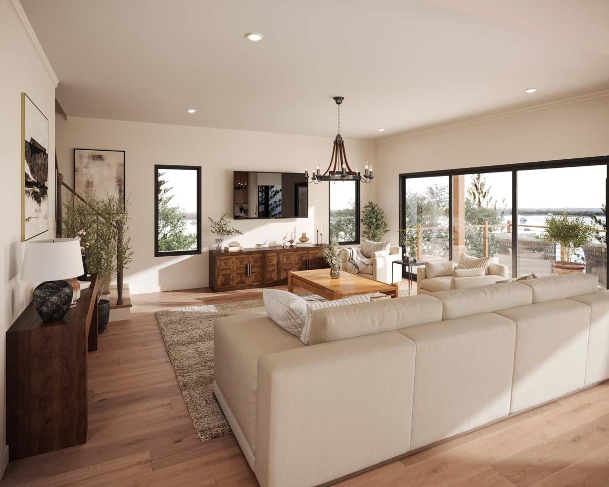 Great room with sectional sofa, wooden furniture, large windows, and fireplace. Open layout connects to outdoor living space.