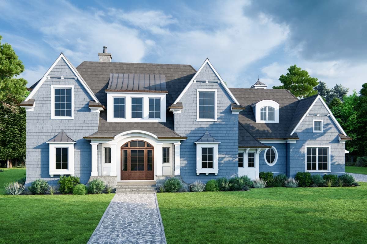 House plan exterior with multiple gables, a front entry with columns, dormers, and a slate roof. Features shingle siding and arched entry door.