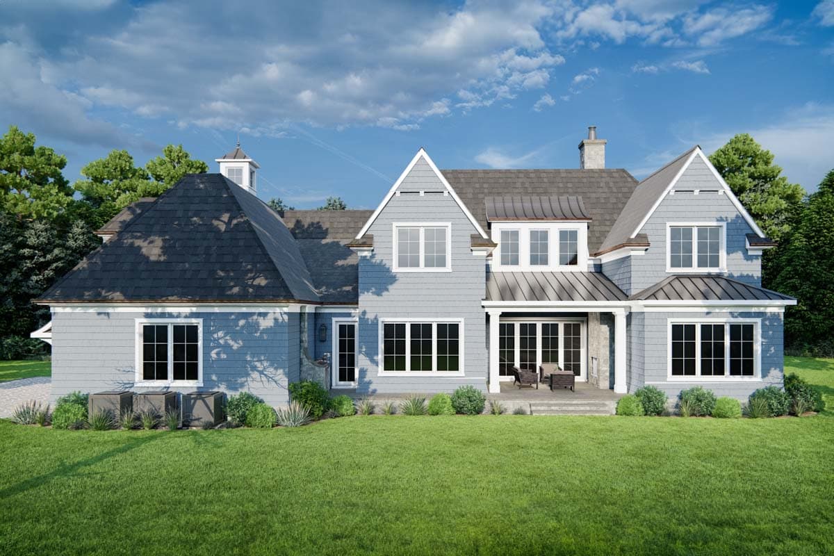 House plan exterior: Light blue siding, multi-story, gabled roofs, dormer windows, covered porch with double doors, and chimney.