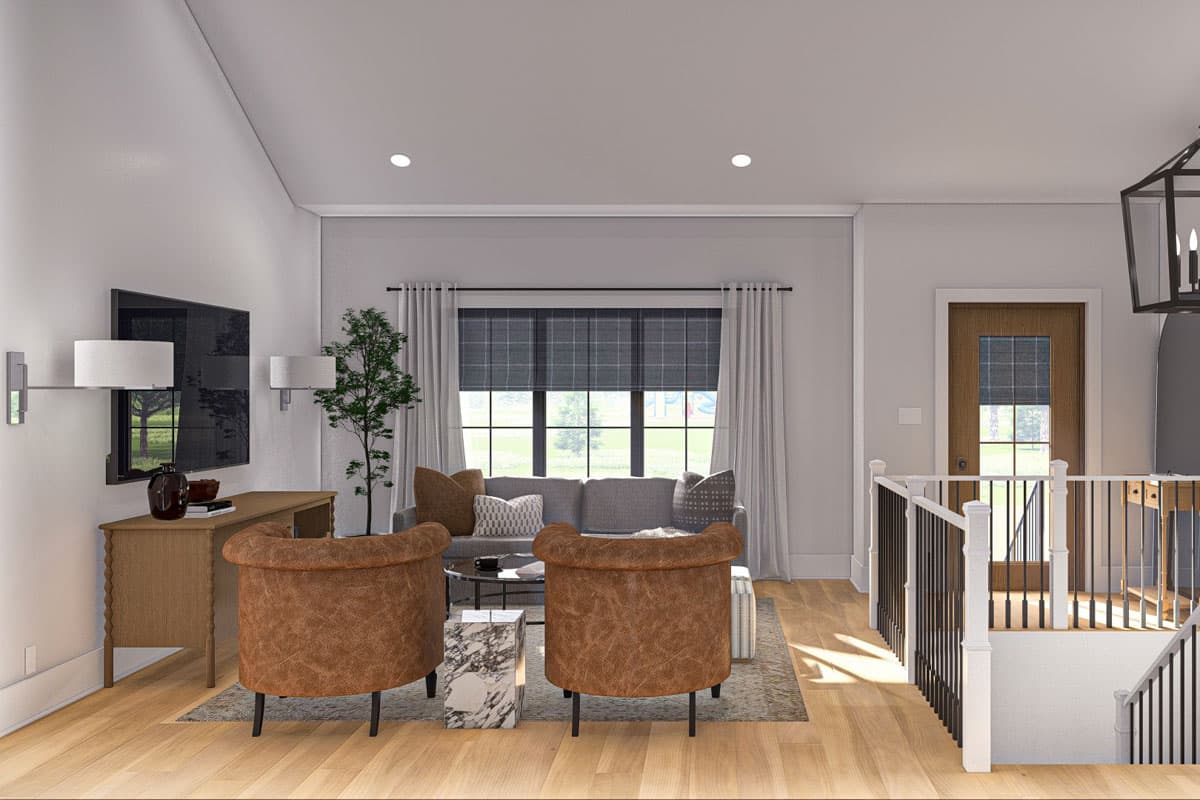 Interior view: Living room with sofa, two armchairs, coffee table, media console, and stairs.